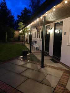 a patio with lights on the side of a house at Primrose Cottage Westhead in Westhead