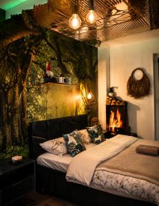 a bedroom with a bed and a tree mural at JACUZZI & SAUNA Apartament Warszawa Wola in Warsaw