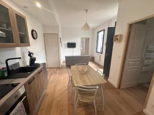 a kitchen and dining room with a table and chairs at Aquero Lourdes T2 in Lourdes +1 photo