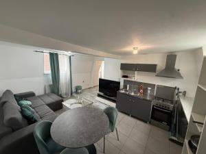 a living room with a couch and a table at Appartement in Roubaix