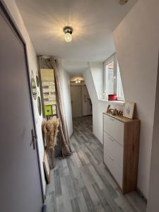 an attic hallway with a staircase and a room at Appartement in Roubaix