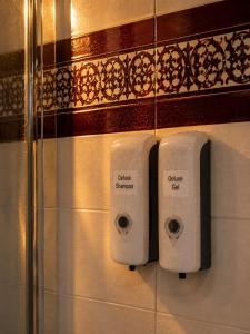 a couple of white soap dispensers on a wall at Deluxe Mogán Beach Apt 1 in Puerto de Mogán +18 photos