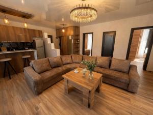 a living room with a couch and a table at Villa Tba near Borjomi, Tsemi and Sadgeri in Tsemi +31 photos