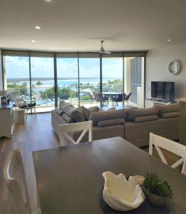a living room with a couch and a table at The Dunes Cotton Tree in Maroochydore