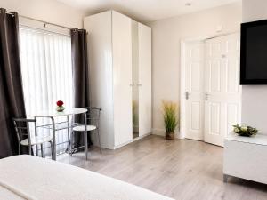 a bedroom with a bed and a table and a mirror at The lodge in Rushbrooke