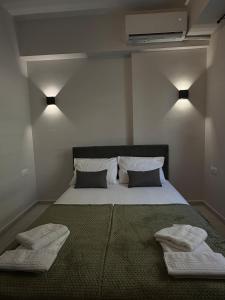 a bedroom with a large bed with two towels on it at Lavandula in Xanthi