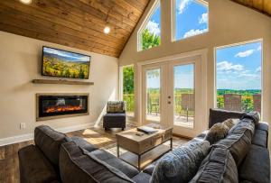 a living room with a large couch and a fireplace at Broadview, River, Golf Course, Games, free Attraction Tickets, WIFI!!! in Kodak