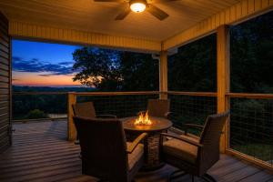 a screened in porch with a table and chairs with a fire at Broadview, River, Golf Course, Games, free Attraction Tickets, WIFI!!! in Kodak