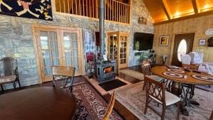 a living room with a table and a wood stove at Elkwood Manor Bed & Breakfast in Pagosa Springs