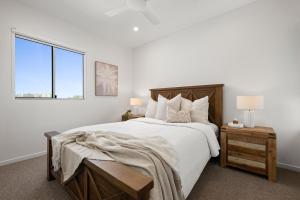 a white bedroom with a large bed and a window at The Dunes Cotton Tree in Maroochydore +110 photos
