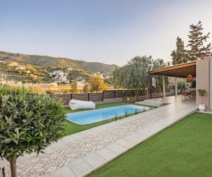 a swimming pool in the middle of a yard at Seaside Breeze Villa - Beachfront, Private Pool, BBQ in Agia Pelagia