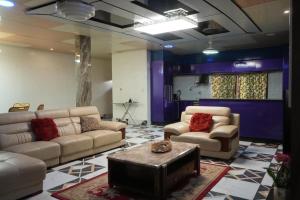 a living room with two couches and a table at Zions Apartments in Elephant Island