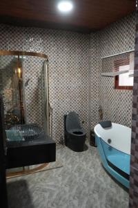 a bathroom with a tub and a sink and a toilet at Zions Apartments in Elephant Island +6 photos