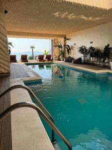 a swimming pool with a view of the ocean at Festim Villa Hotel in Kaninë
