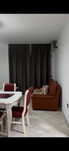 a living room with a table and a couch at Dina in Golem