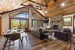 a living room with a table and a fireplace at Angels Share in Seven Devils