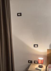 a room with a bed and a table with a lamp at Lina in Golem