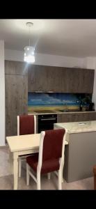a kitchen with a white table and two chairs at Lina in Golem