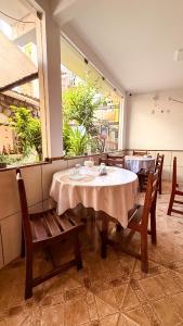 a dining room with a table and chairs and a window at Pousada Timbalada in Morro de São Paulo