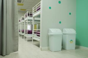 a library with two trash cans in a room at Augas Quentes Hostel in Ourense