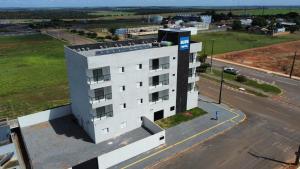 an overhead view of a white building on a street at Hotel Blox Sorriso in Sorriso +20 photos