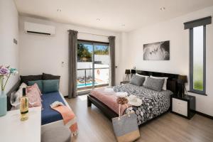 a bedroom with a bed and a table at Villa Clara do Sol in Estói +21 photos
