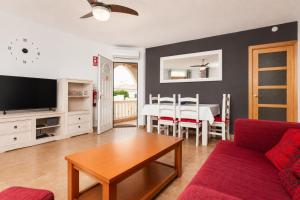 a living room with a couch and a table at Villa Maria Large Private Pool AC WiFi in Cala en Porter