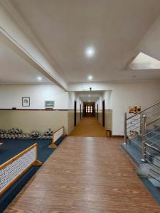 an empty hall in a building with a hallway at The Yak Motel in Skardu