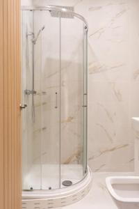 a shower with a glass door in a bathroom at 2 BR Apartment- Private Parking in Newport