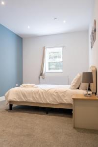a bedroom with a bed and a desk and a window at 2 BR Apartment- Private Parking in Newport