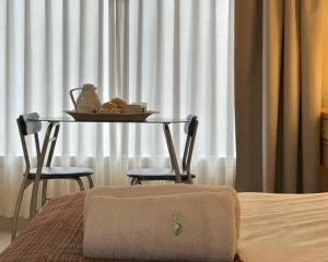 a table with a tray of food on it next to a window at Los Plátanos cabañas & suites in Moreno