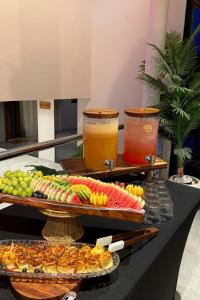 a buffet of food and drinks on a table at Groves Chalet in Rumays