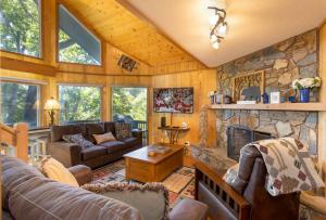 a living room with a stone fireplace at Beary Blessed Cabin in Fleetwood +16 photos