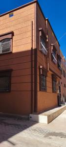 a building with barred windows on the side of it at Tata hausse in Tatta