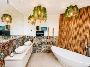 a bathroom with two sinks and a tub at VistaBlu Camps Bay in Cape Town +117 photos