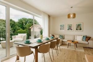a living room with a table and chairs at Aria Apartments in Prievidza