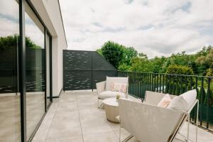 a balcony with chairs and a table on a balcony at Aria Apartments in Prievidza