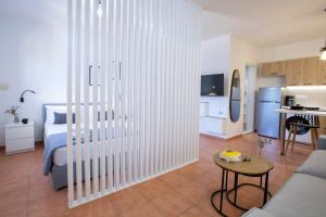 a living room with a bed and a kitchen at Skyview Suites in Lefkada