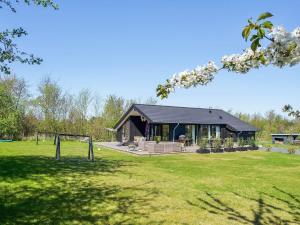a house with a soccer goal in a field at Seaside Stay with the Sauna in Hørve
