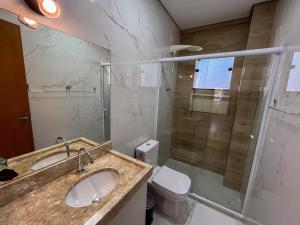 a bathroom with a sink and a toilet and a shower at Casa Amoreira Paraty in Paraty