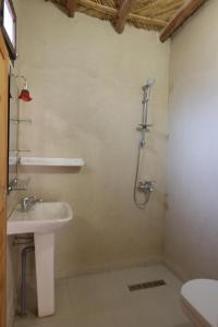 a bathroom with a sink and a shower at Maison d hôtes Dar Charach in Ouarzazate +62 photos
