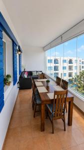 a dining room with a table and chairs in a living room at Spacious Apartment with views to sea and pool Kabila vista Families only in Marina Smir