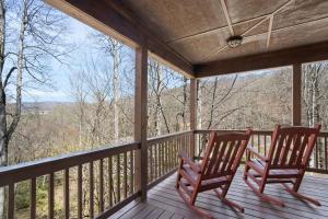 two rocking chairs on a porch with a view at Eagles View in Boone