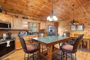 a kitchen with a table and chairs in a cabin at Eagles View in Boone