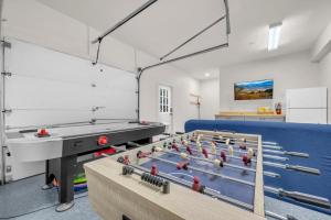 a gym with a ping pong table in a room at Heavens Door in Beech Mountain