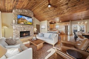 a living room with a couch and a fireplace at Alpine Retreat in Seven Devils