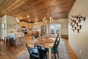 a dining room and kitchen with a table and chairs at Alpine Retreat in Seven Devils +49 photos