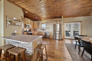a kitchen with a large island in the middle at Alpine Retreat in Seven Devils