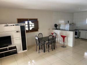 a kitchen and dining room with a table and chairs at Casaavatar12 in Piranhas