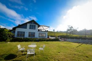 a table and chairs in front of a house at The Tea Garden - Complimentary Breakfast, Near Lake Gregory in Nuwara Eliya